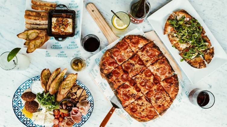 Dwayne Johnson eating a pizza whilst a huge explosio