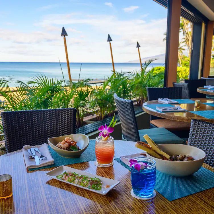 Open-air dining with an ocean view. - Sea House Restaurant at Napili Kai Beach Resort, Lahaina, HI