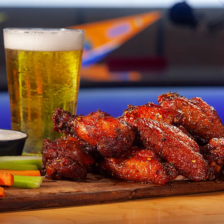 glass of beer, wings with carrots, celery sticks - The Rose - Playbook Sports Bar & Grill，VADumfries