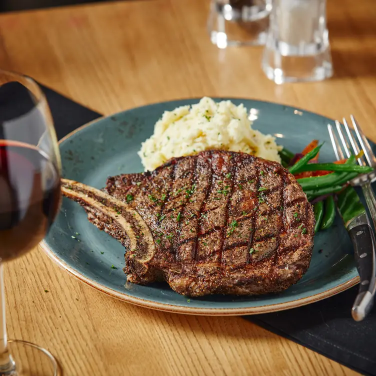 16oz Bone-In Rib Steak - Milestones Grill + Bar - Langley BC Langley