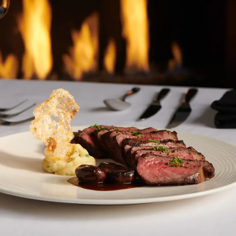 Rare Steak at Monarch Chophouse in front of a fire - Monarch Chophouse, Black Hawk, CO