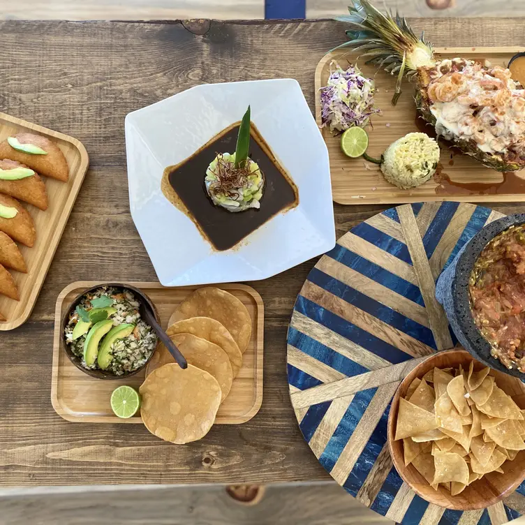 Wooden table filled with assorted seafood tapas  - Coco Beach Presents, LONG BEACH, CA