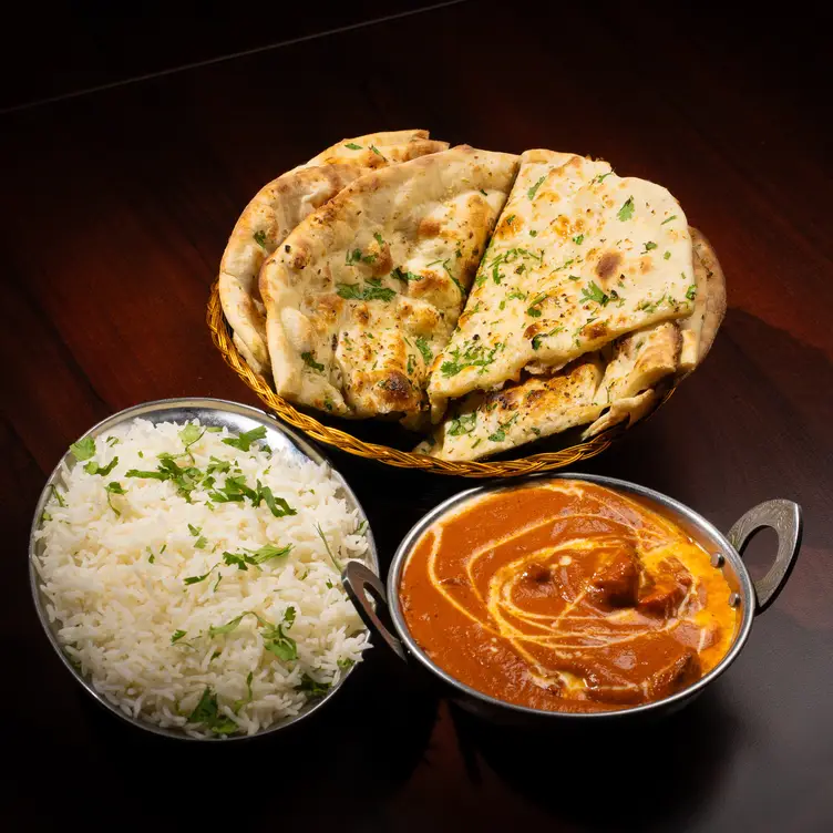 Butter chicken, garlic naan, and rice. - Delhi Oven, Sacramento, CA