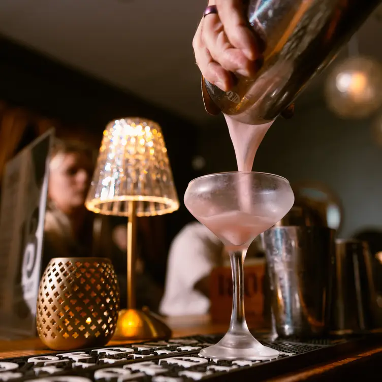 A cocktail being poured at a bar. - Ellipsis, Wilmington, NC