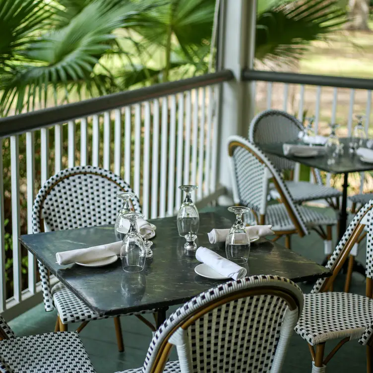 tables and chairs on veranda - Audubon Clubhouse by Dickie Brennan & Co., New Orleans, LA