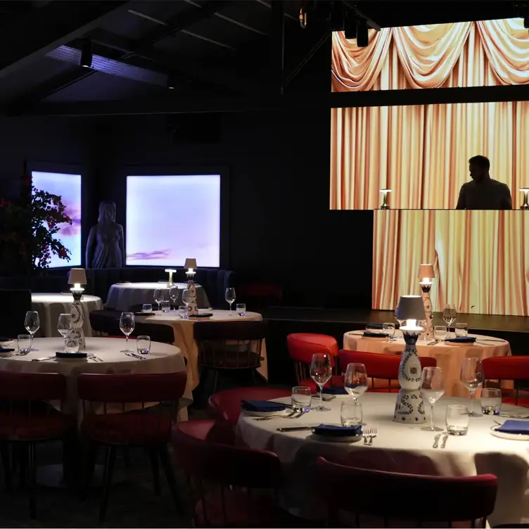 dim and romantically lit tables in front of stage - Nyx - Live Music Restaurant, Brentwood, Essex