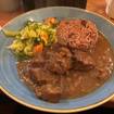 Una foto de Curried Goat de un restaurante