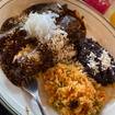 A photo of mole enchiladas of a restaurant