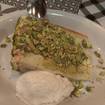 Una foto de pistachio-ricotta-cream layer cake de un restaurante