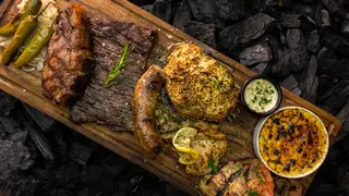 Una foto del restaurante Carbón Parrilla de Barrio - León