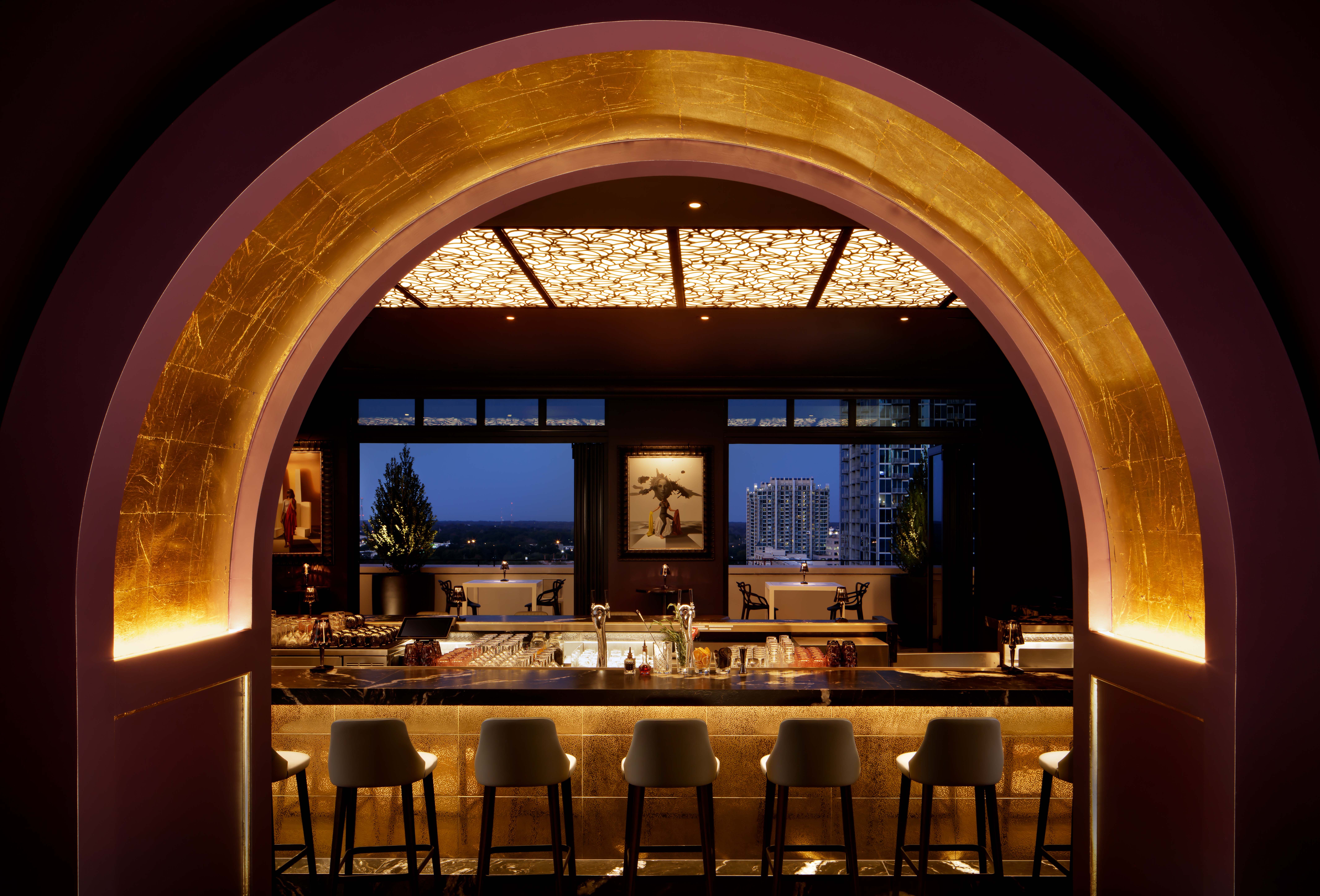Búho rooftop bar at Grand Bohemian Charlotte with illuminated arches and evening city views