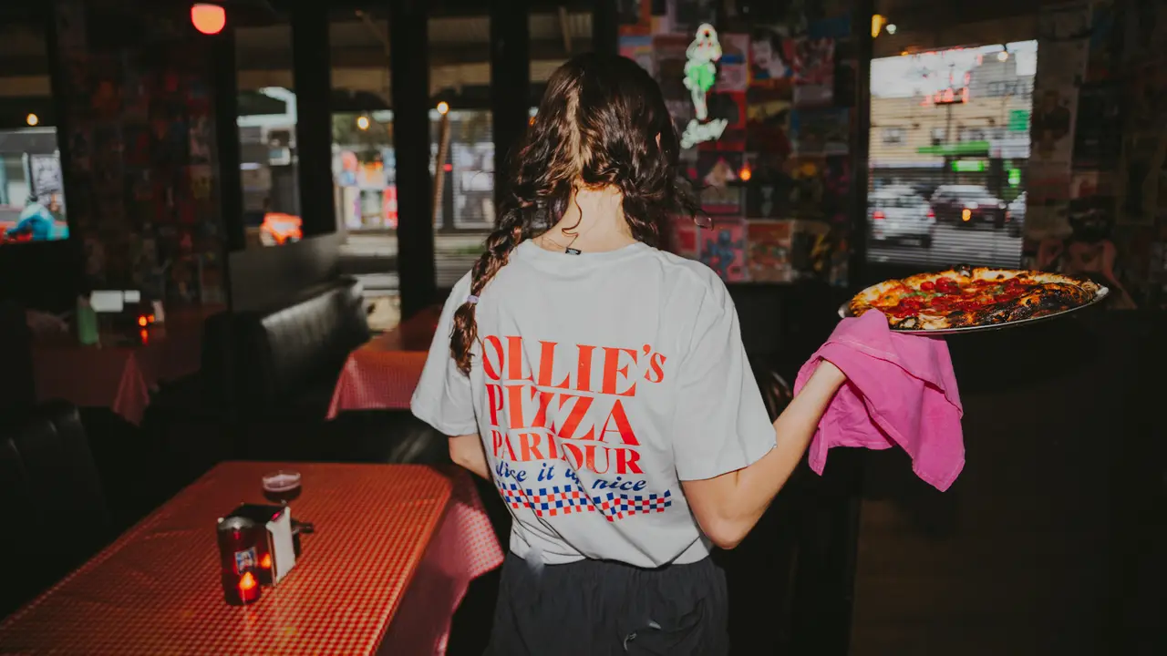 An Ollie's Pizza Parlour waitress holding pizza - Ollie's Pizza Parlour, Brunswick, AU-VIC