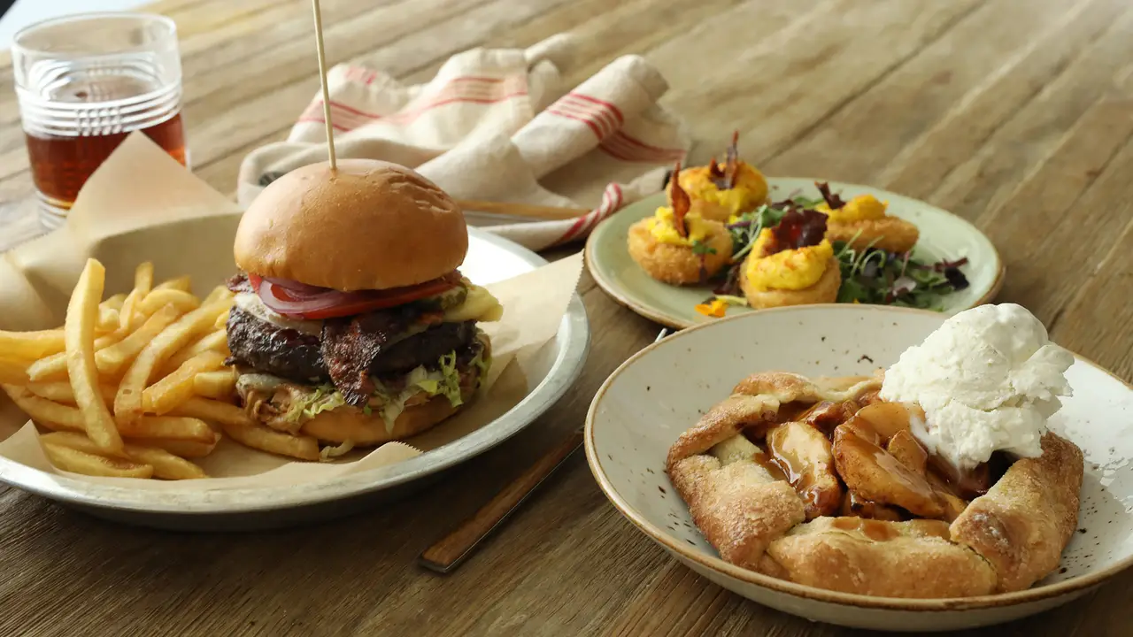 Variety of American food served on a wood table - Lazy Dog Restaurant & Bar - Cupertino, Cupertino, CA