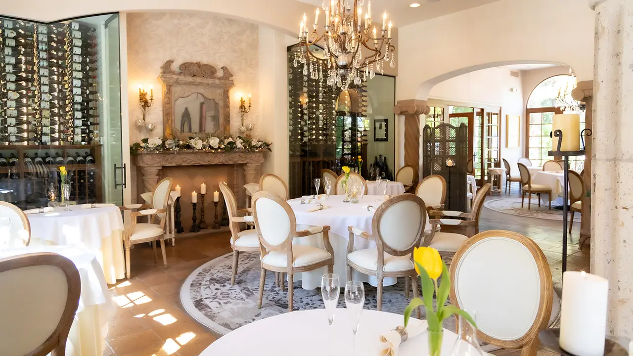 Dining room with white tablecloths and wine cellar - Cafe Monarch, Scottsdale, AZ