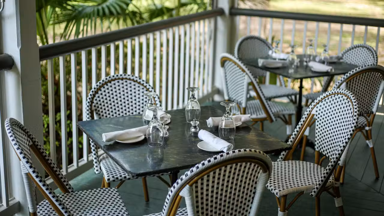 tables and chairs on veranda - Audubon Clubhouse by Dickie Brennan & Co., New Orleans, LA
