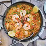 Paella and a Bottle of Wine Foto
