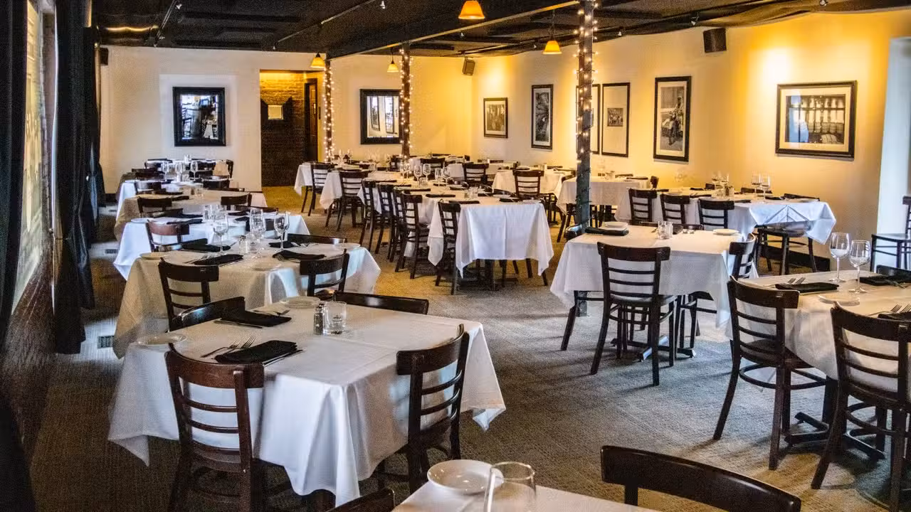 Tables with white tablecloths and ambient light - Bourbons Bistro, Louisville, KY